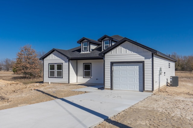 view of front of house with central AC and a garage