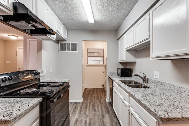 kitchen with sink, white cabinets, light stone counters, black appliances, and a textured ceiling