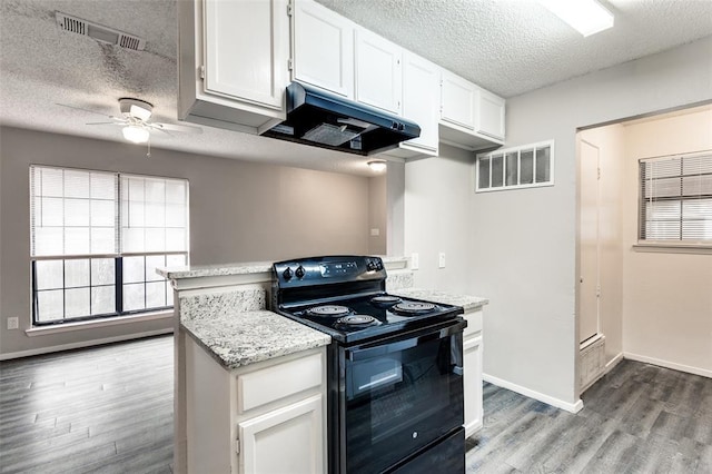 kitchen featuring a textured ceiling, light wood-type flooring, electric range, ceiling fan, and white cabinets