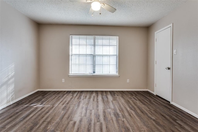 unfurnished room with ceiling fan, dark wood-type flooring, and a textured ceiling