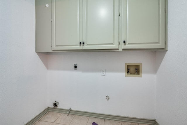 washroom featuring light tile patterned flooring, gas dryer hookup, cabinets, washer hookup, and hookup for an electric dryer