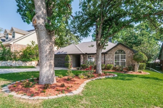 view of front of property featuring a garage and a front yard