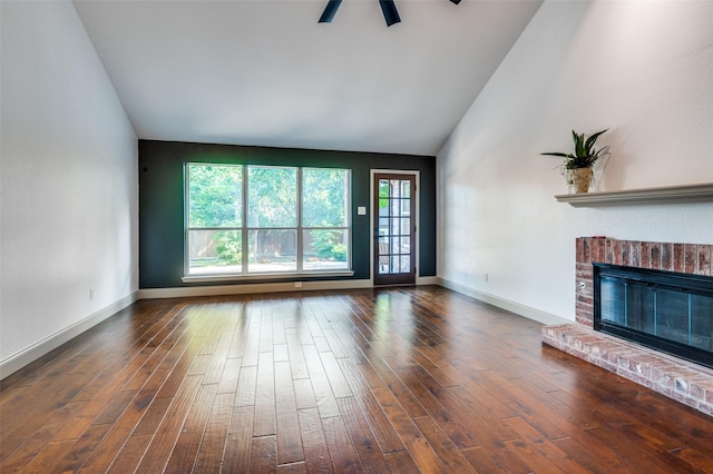 unfurnished living room featuring a fireplace, wood-type flooring, ceiling fan, and vaulted ceiling