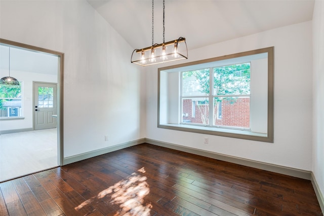 unfurnished dining area with lofted ceiling and dark hardwood / wood-style floors