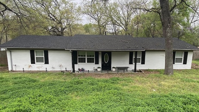 ranch-style home with a front lawn