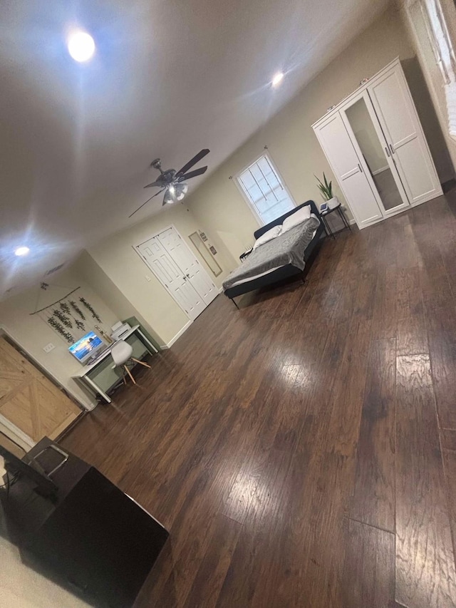 unfurnished living room with dark hardwood / wood-style floors and ceiling fan