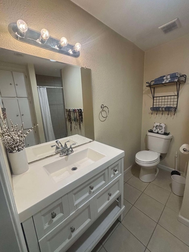 bathroom featuring vanity, toilet, curtained shower, and tile patterned flooring