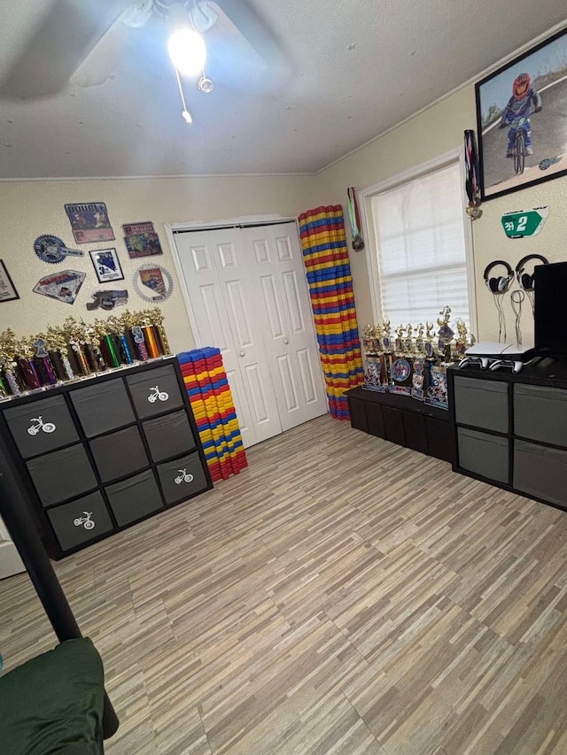 interior space featuring light hardwood / wood-style floors, a closet, and ceiling fan