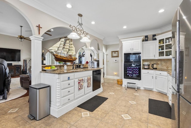 kitchen featuring white cabinetry, decorative light fixtures, dark stone counters, decorative columns, and black appliances