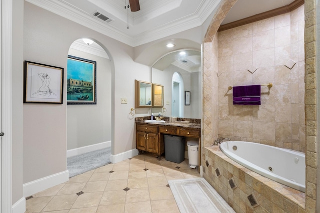 bathroom with tile patterned floors, ornamental molding, vanity, and tiled tub