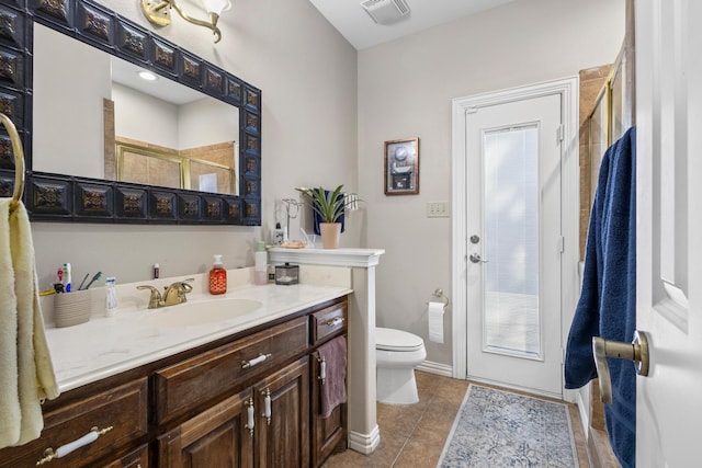 bathroom with tile patterned floors, vanity, toilet, and an enclosed shower