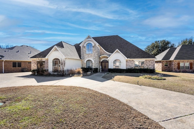 french provincial home featuring a front lawn