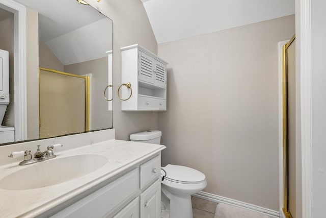 bathroom featuring tile patterned floors, toilet, vaulted ceiling, vanity, and a shower with door