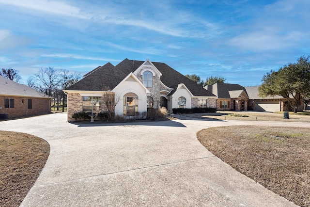 french country style house featuring a garage