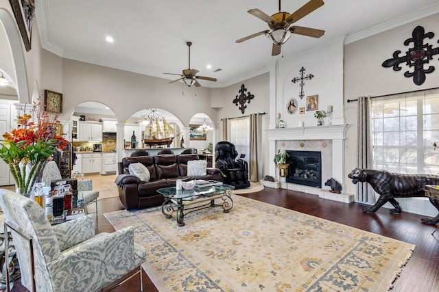 living room featuring a high ceiling, crown molding, and dark wood-type flooring