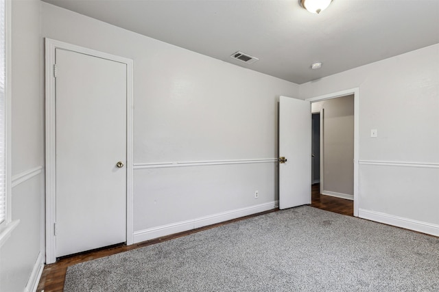 unfurnished bedroom featuring dark hardwood / wood-style flooring