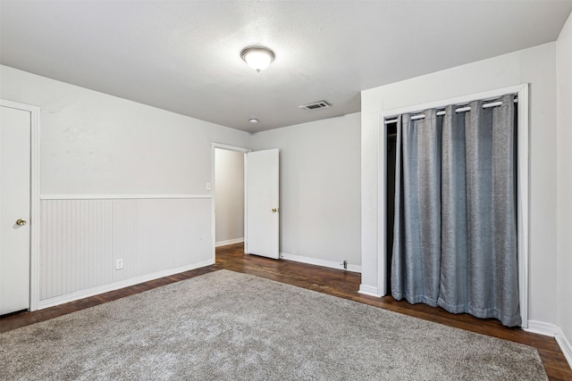 2325 Halbert St, Fort Worth, TX 76112 - unfurnished bedroom with dark wood finished floors and a wainscoted wall