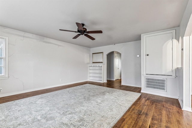 unfurnished living room with ceiling fan and dark hardwood / wood-style flooring