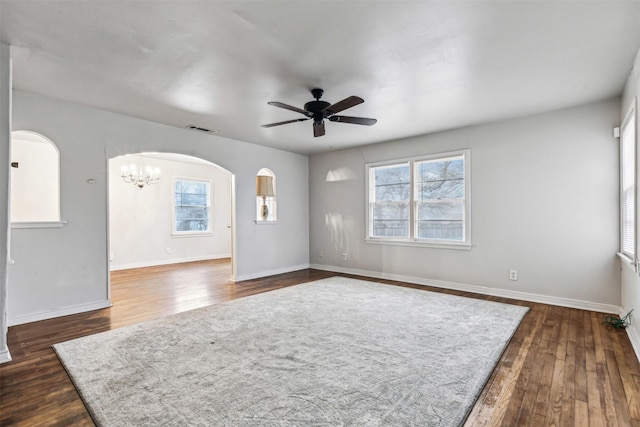 2325 Halbert St, Fort Worth, TX 76112 - empty room with arched walkways, ceiling fan, plenty of natural light, and dark wood-style floors