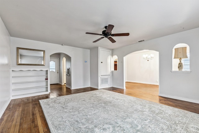 2325 Halbert St, Fort Worth, TX 76112 - unfurnished living room with arched walkways, dark wood-style flooring, and a ceiling fan