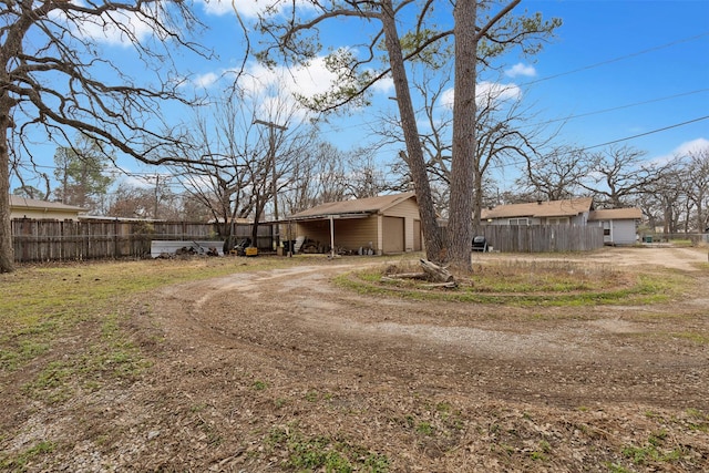 2325 Halbert St, Fort Worth, TX 76112 - rear view of house featuring dirt driveway and a detached garage