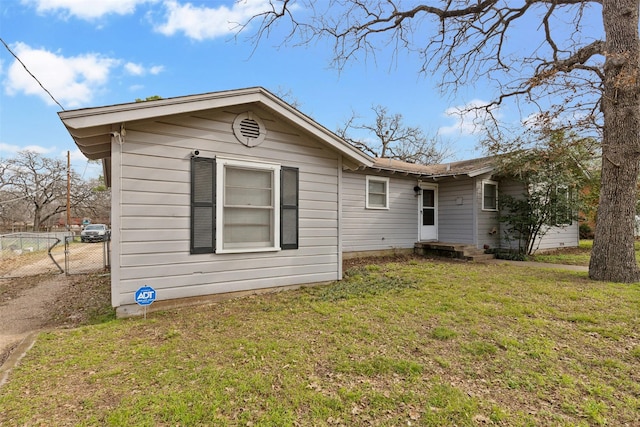 rear view of house with a lawn