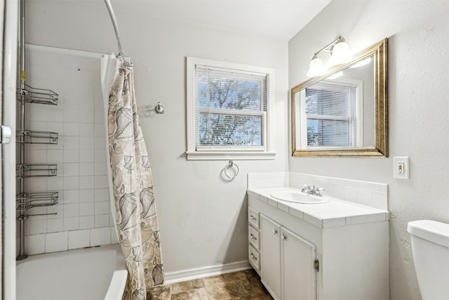 full bathroom with vanity, shower / tub combo, and toilet