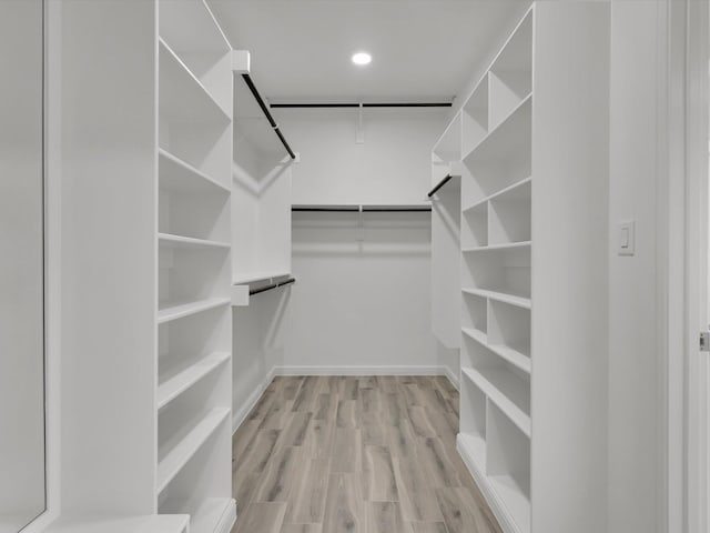 walk in closet featuring light hardwood / wood-style flooring