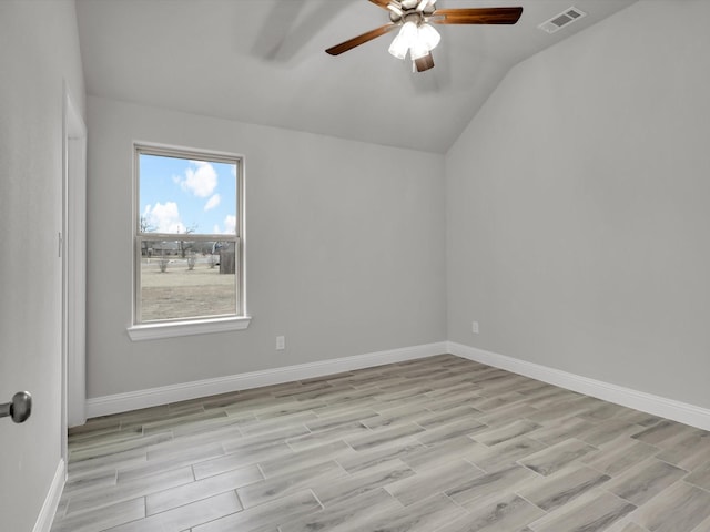 spare room featuring lofted ceiling, ceiling fan, and light hardwood / wood-style flooring