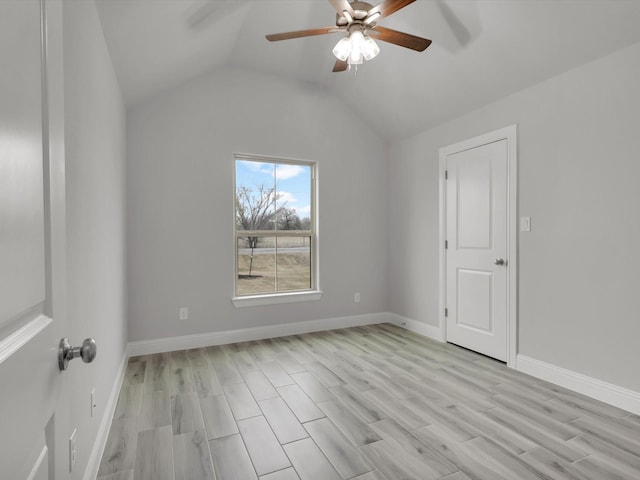 unfurnished room with vaulted ceiling, light hardwood / wood-style floors, and ceiling fan