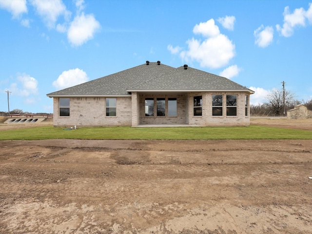 back of house with a yard and a patio