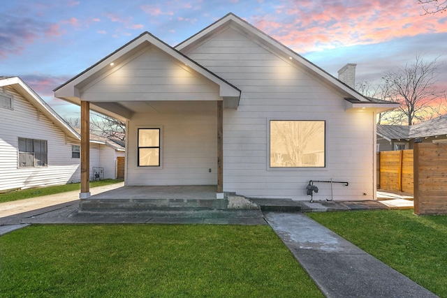 bungalow-style house with a yard