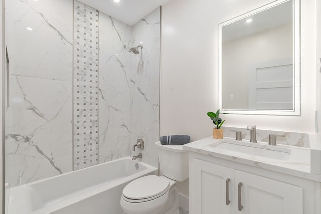 full bathroom with vanity, toilet, and tiled shower / bath combo