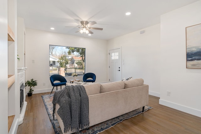 living room featuring wood-type flooring and ceiling fan