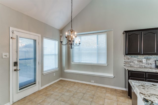 unfurnished dining area with lofted ceiling and a chandelier