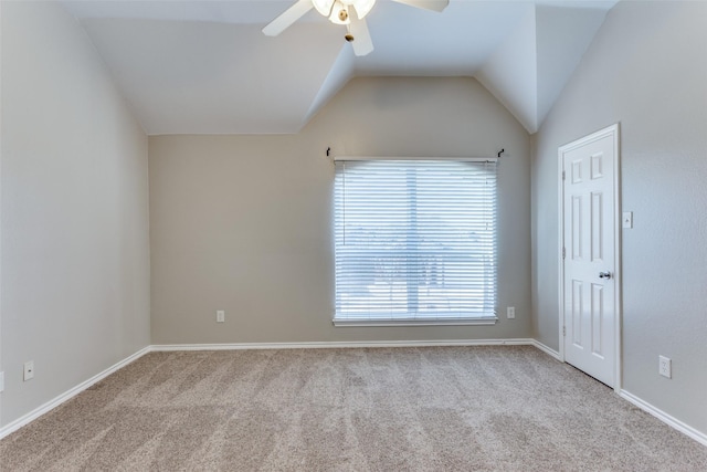 carpeted spare room with vaulted ceiling and ceiling fan