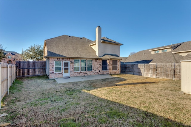 back of house featuring a yard and a patio area