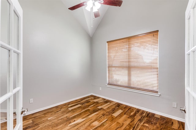 spare room with hardwood / wood-style floors, vaulted ceiling, and ceiling fan