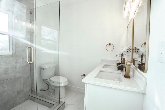 bathroom featuring tile patterned flooring, vanity, walk in shower, and toilet