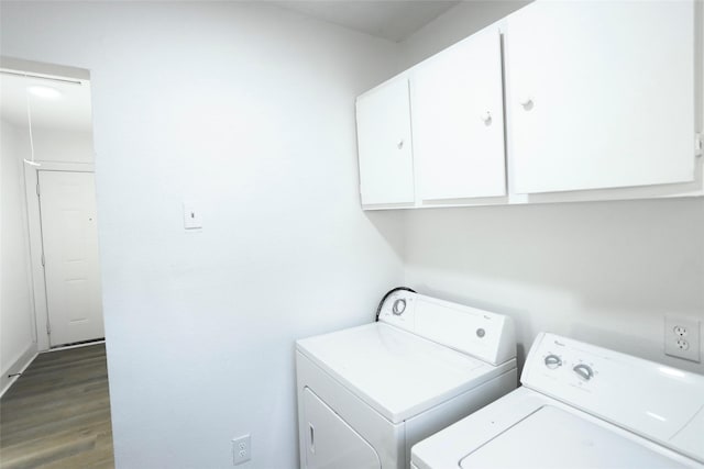 washroom with cabinets, dark hardwood / wood-style flooring, and washer and dryer