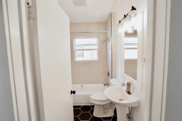 full bathroom with tiled shower / bath combo, sink, tile patterned floors, and toilet