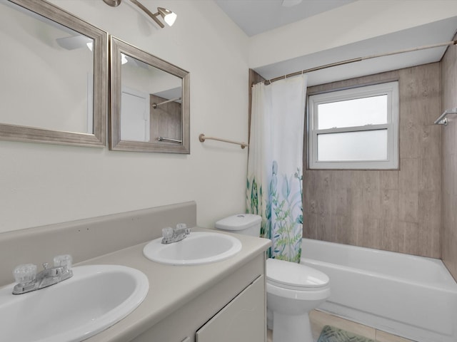 full bathroom featuring vanity, shower / bathtub combination with curtain, tile patterned floors, and toilet