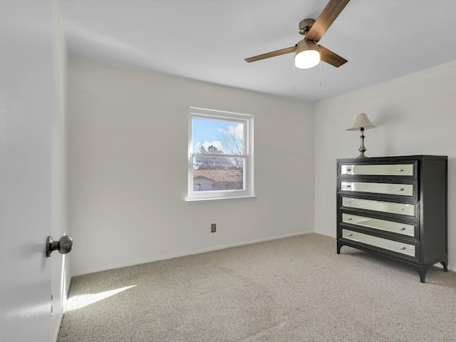 unfurnished bedroom with ceiling fan and carpet