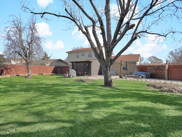 view of yard with a sunroom and a patio