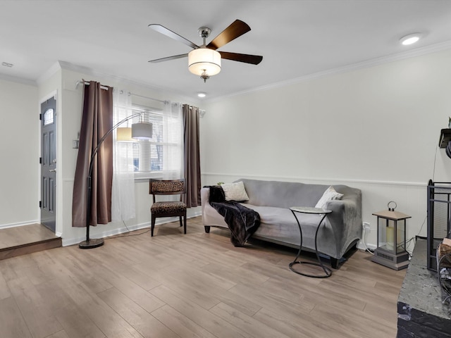 living area featuring ornamental molding, ceiling fan, and light hardwood / wood-style flooring