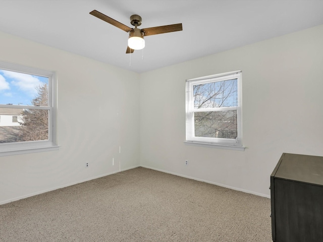 unfurnished room featuring ceiling fan and light carpet