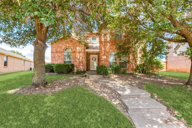 view of front facade featuring brick siding and a front lawn