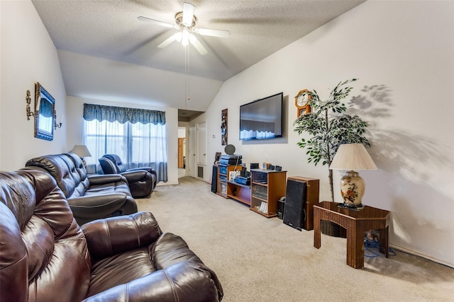 living room with ceiling fan, carpet flooring, vaulted ceiling, and a textured ceiling