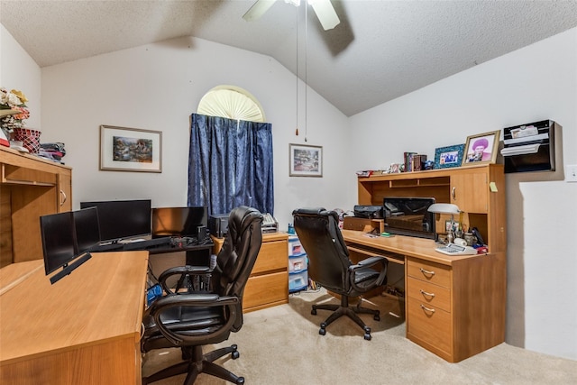 carpeted office space featuring ceiling fan, vaulted ceiling, and a textured ceiling