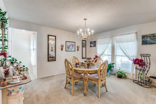 dining room with light carpet, a notable chandelier, and a textured ceiling